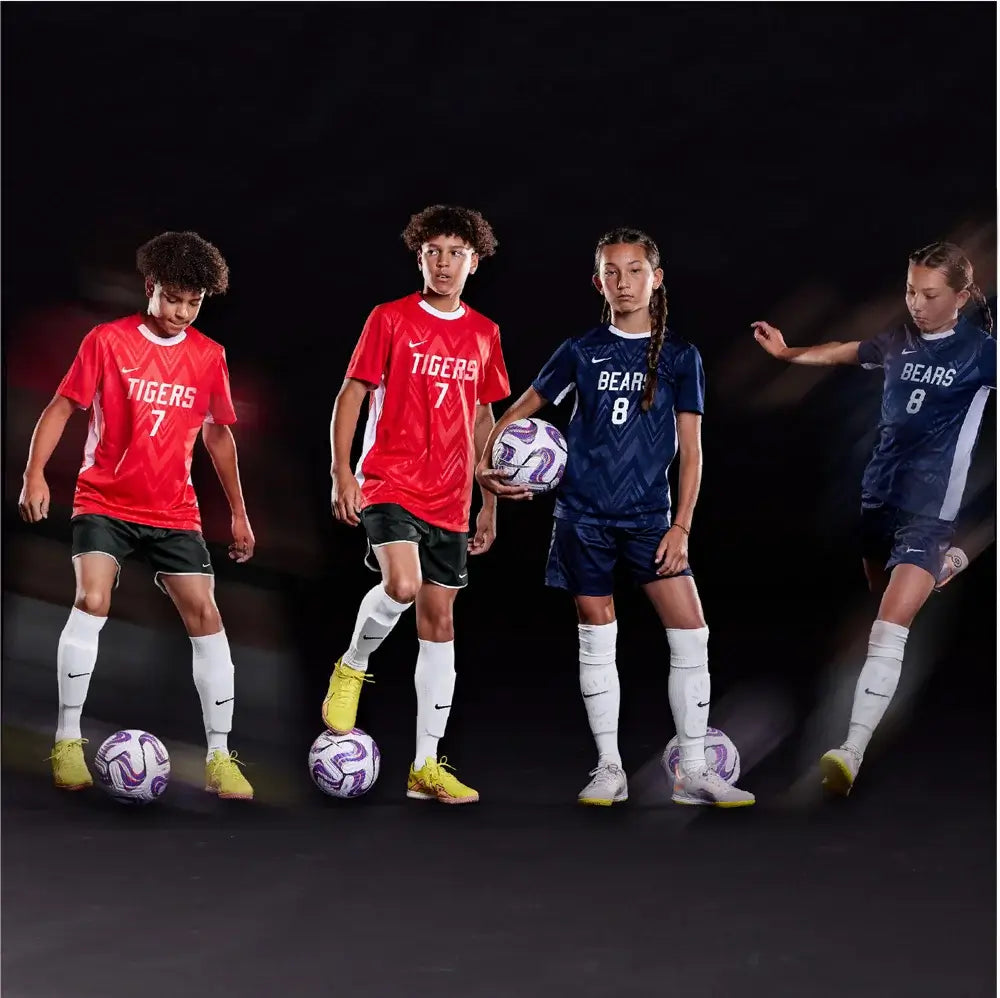 soccer players in red and blue uniforms with soccer balls